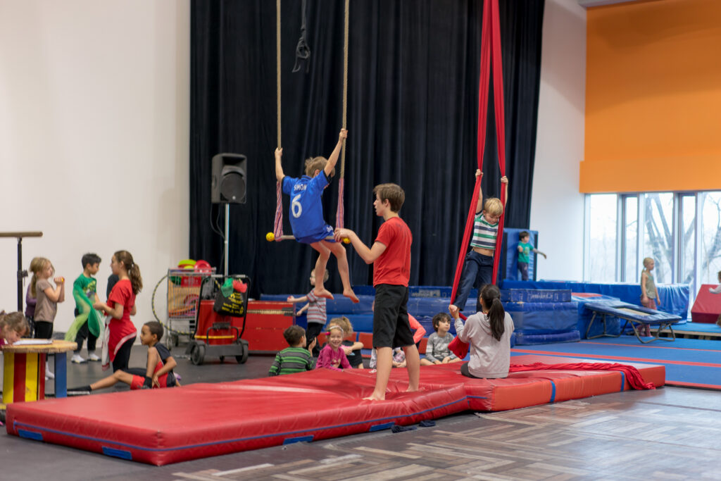 Indoor circus workshop for children: trapeze and aerial silks classes with instruction in a safe environment.